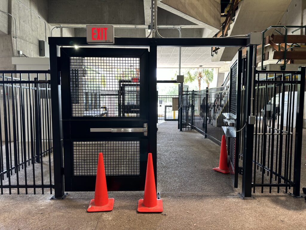 Preventing unauthorized access with black metal security gate and fencing
